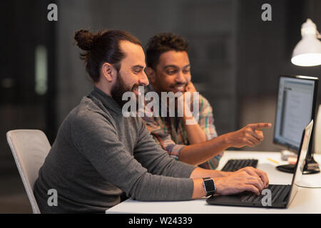 creative team with computer working late at office Stock Photo