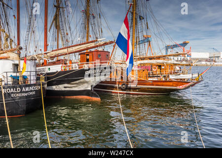 Sterns of tall ships in the harbor of Kiel, Germany Stock Photo