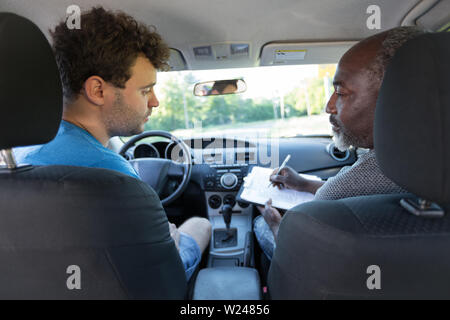 Driving Instructor And Student In The Front Of The Car Stock Photo