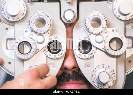 Patient in modern ophthalmology clinic checking the eye vision . Stock Photo
