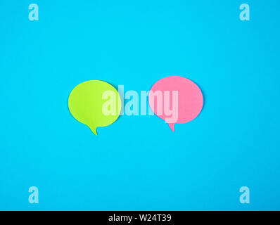 two color paper stickers on a blue background, close up Stock Photo