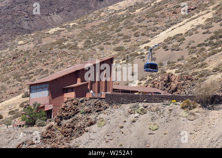 Cable car station at the foot of the Teide volcano. Blue cabin begins to climb to the top. National Park Teide, Tenerife, Canary Islands. Stock Photo