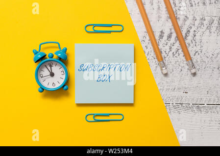 Text sign showing Subscription Box. Business photo text button if you clicked on will get news or videos about site Notepad clips colored paper sheet Stock Photo