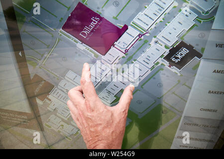 mans hand using pinch movement on touchscreen directory at St Johns Town Center Jacksonville Florida USA Stock Photo