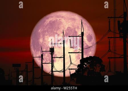 Full Harvest Moon back on silhouette power electric line and pole on night sky, Elements of this image furnished by NASA Stock Photo