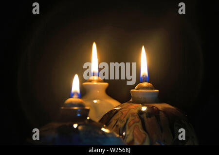 Oil lamp candle flame in the dark with halo effect Stock Photo