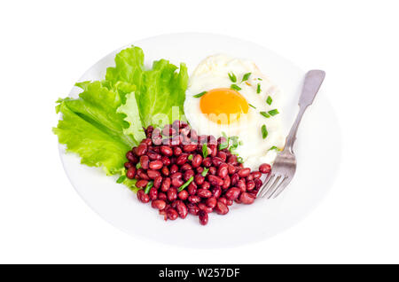 Red beans, lettuce and fried egg for breakfast. Stock Photo