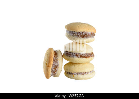Delicious Argentinian cookies alfajores with cream dulce de leche close-up isolated. White vanilla macaroons on white background. French delicate dessert for Breakfast . Stock Photo
