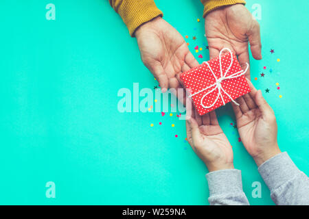 Male gives a gift to female with copy space background.happiness moment concepts ideas Stock Photo