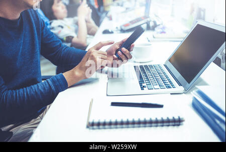 Male using computer laptop and smart phone in office.business lifestyle and organization concepts Stock Photo