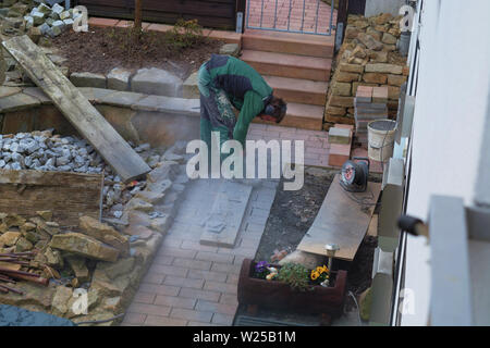 Reworking with technology Tile cutting with an angle grinder Stock Photo