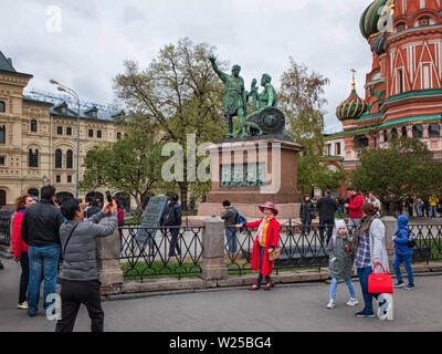 Moscow, Russia - May 2, 2019. Chinese tourists taking a pictures opposite St. Basil's cathedral Stock Photo