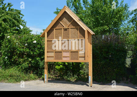 Big wood insect house hotel structure created to provide shelter for insects like bees to prevent extinction Stock Photo