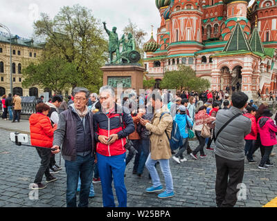 Moscow, Russia - May 2, 2019. Chinese tourists taking a pictures opposite St. Basil's cathedral Stock Photo