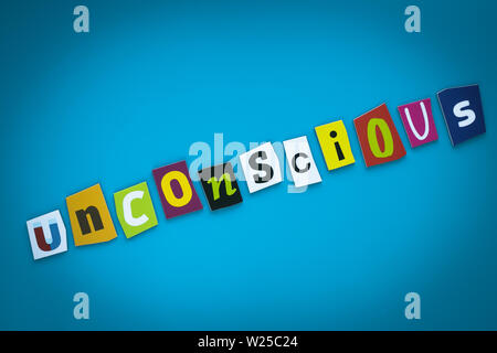 A single word - Unconscious - from cut colorful letters on a blue background. Text on banner. Inscription on card. Psychologic concept. Caption, headi Stock Photo