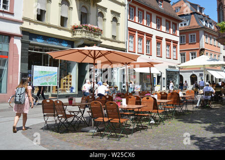 Heidelberg, Germany - June 2019: Outdoor cafe at marketsquare in old city center on a sunny day Stock Photo