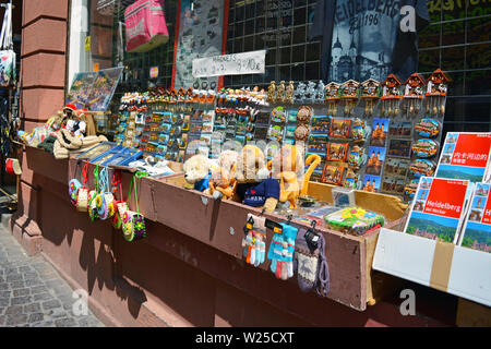 Souvenir shops offering various local trinkets like fridge magnets and plush toys in histrocail city center of Heidelberg, Germany Stock Photo