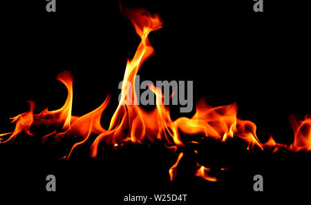 Fire flames on Abstract art black background, Burning red hot sparks rise, Fiery orange glowing flying particles Stock Photo