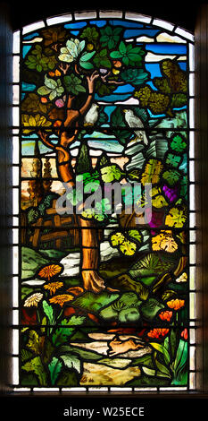 UK, Cumbria, Sedbergh, Marthwaite, St Gregory’s church window, depicting naturalistic woodland scene Stock Photo