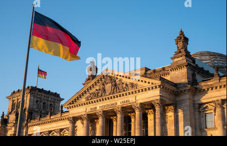 Bundestag building, Parliament of the Federal Republic of Germany, with German flag flying outside. Photographed in late afternoon during the heatwave Stock Photo