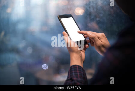 Close up male hands holding cell telephone,smartphone in night Stock Photo