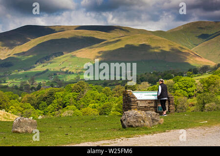 UK, Cumbria, Sedbergh, Frostrow and Soolbank, visitor at Tom Croft Hill viewpoint enjoying view of Howgill Fells