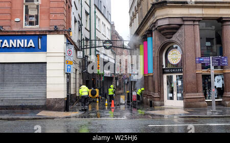 Liverpool Merseyside UK - Street cleaners at work in the Mathew Street the morning after a long night partying in the famous Cavern Bar area Stock Photo