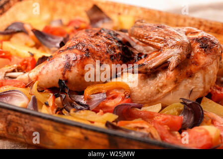 Close up of  whole baked chicken and vegetables Stock Photo