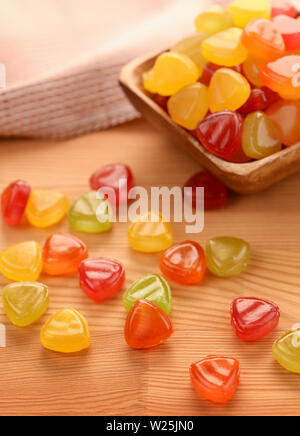 Colorful hard candies on unpainted wooden table Stock Photo