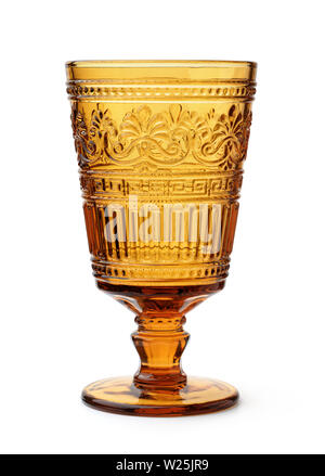 Front view of vintage amber pressed glass goblet isolated on white Stock Photo