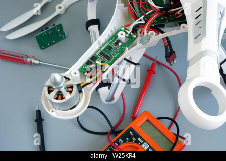 Disassembled drone quadrocopter under repair for fixing problems. Stock Photo
