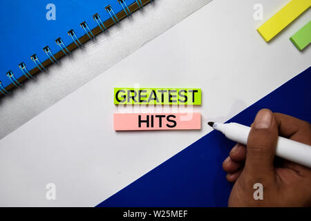 Greatest Hits text on sticky notes with color office desk concept Stock Photo