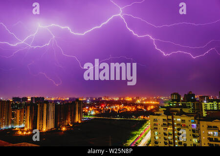 Multiple lighting bolts thunder  during a storm with a dramatic blue sky in noida, delhi India  - Image Stock Photo