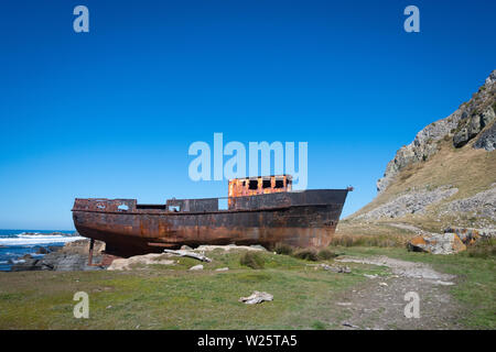 Fishing boat washed up on shore, White Rock, Wairarapa, North Island, New Zealand Stock Photo