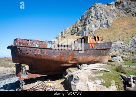 Fishing boat washed up on shore, White Rock, Wairarapa, North Island, New Zealand Stock Photo