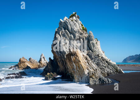 Waves breaking on rocks, White Rock, Wairarapa, North Island, New Zealand Stock Photo
