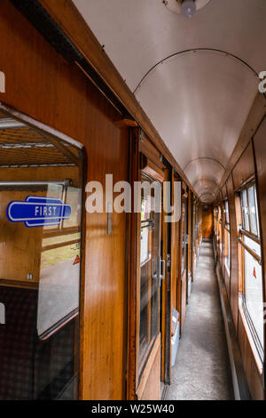 Inside a vintage corridor style heritage railway carriage Stock Photo