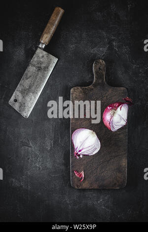 Rustic Chopping Board and Halved Red Onion with Old Meat Cleaver Stock Photo
