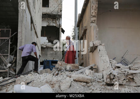 Muhambal, Syria. 06th July, 2019. People inspect the rubble of a building that was destroyed in an airstrike, allegedly carried out the day before by the Syrian government on the town of Muhambal in the rebel-held Idlib Province. Credit: Anas Alkharboutli/dpa/Alamy Live News Stock Photo