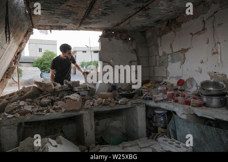 Muhambal, Syria. 06th July, 2019. A man inspects the rubble of a building that was destroyed in an airstrike, allegedly carried out the day before by the Syrian government on the town of Muhambal in the rebel-held Idlib Province. Credit: Anas Alkharboutli/dpa/Alamy Live News Stock Photo