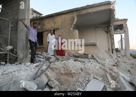 Muhambal, Syria. 06th July, 2019. People inspect the rubble of a building that was destroyed in an airstrike, allegedly carried out the day before by the Syrian government on the town of Muhambal in the rebel-held Idlib Province. Credit: Anas Alkharboutli/dpa/Alamy Live News Stock Photo