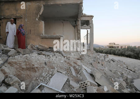 Muhambal, Syria. 06th July, 2019. People inspect the rubble of a building that was destroyed in an airstrike, allegedly carried out the day before by the Syrian government on the town of Muhambal in the rebel-held Idlib Province. Credit: Anas Alkharboutli/dpa/Alamy Live News Stock Photo