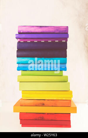 Stack of colorful rainbow books on white background. Toned Stock Photo