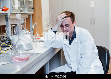 Scientist sleeps at work in the lab Stock Photo