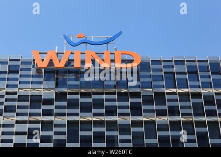 Milan, Italy - April 14, 2016: Wind logo on a building. Wind is an Italian telecom operator which offers integrated mobile, fixed and Internet service Stock Photo - Alamy