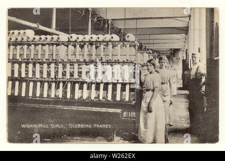 Early postcard printed at bottom is  'Wigan Mill girls,slubbing frames', with overseer / foreman standing beside slubbing frames - a machine used to straighten out the fibres in cotton prior to spinning 'Lancashire Lasses',  circa 1910, Wigan, Greater Manchester, U.K.