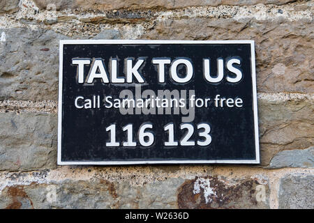 Bristol, UK - June 28th 2019: A sign with the Samaritans phone number - hoping to influence potential suicide victims to ring for help, on Clifton Sus Stock Photo