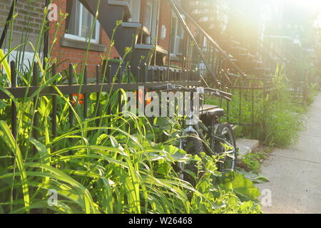 Bike parked on sidewalk in Montreal during a summer day, Rosemont Stock Photo