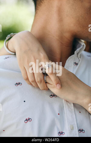 Closeup of a woman hugging a man. Close relationship or flirt or love. Stock Photo