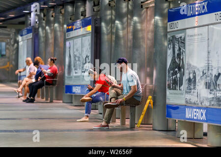 People on smart phones waiting for train, Maverick Station, Boston, Massachusetts, USA Stock Photo